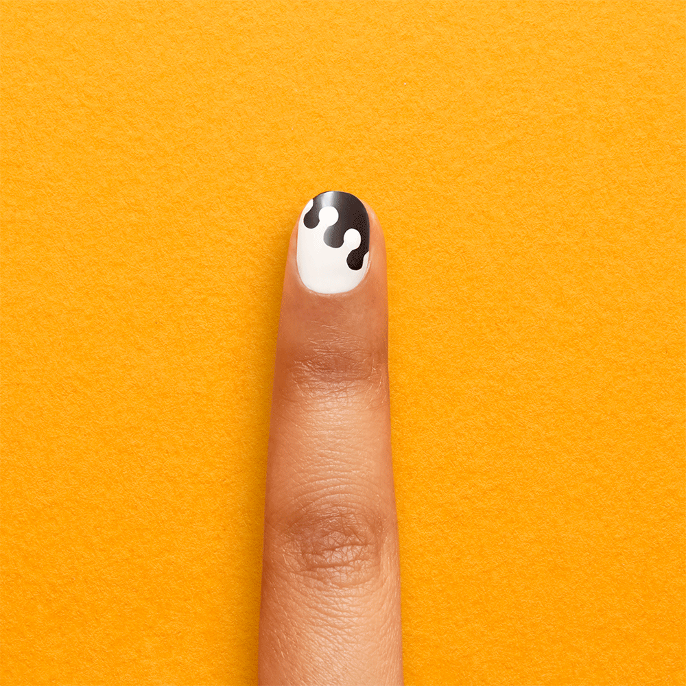 gift adding top coat to polka dot nail art