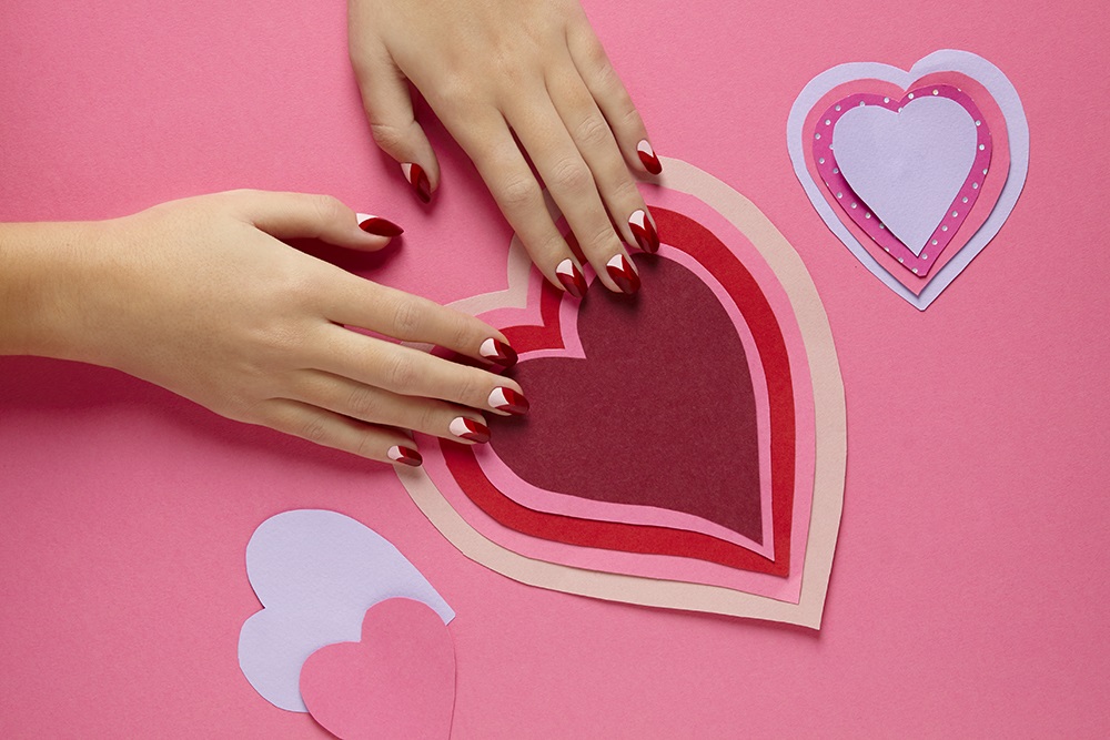 Hands with heart shaped nail art