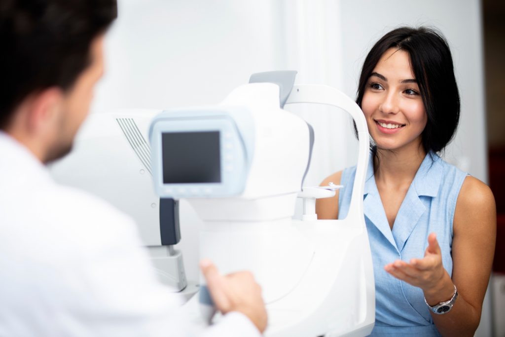 Female speaking with eyecare professional at eye examination