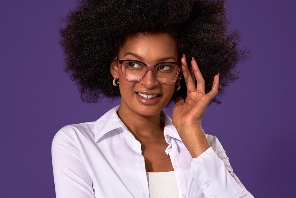 Female wearing glasses with purple background