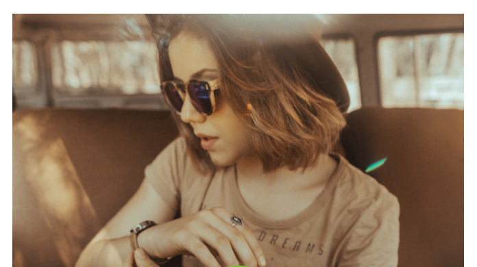 Female wearing sunglasses and hat