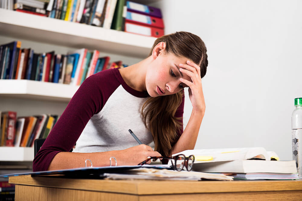 Female studying in a library at university