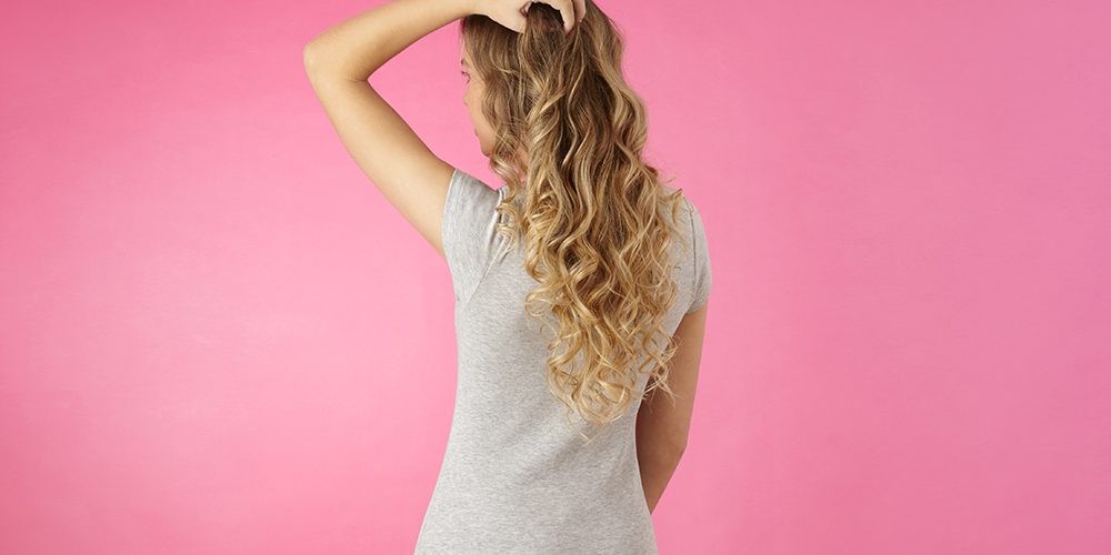 Woman with hand through her long curly hair