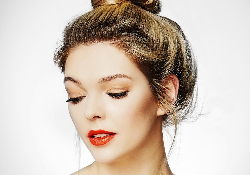 Young female with red lips and a messy bun