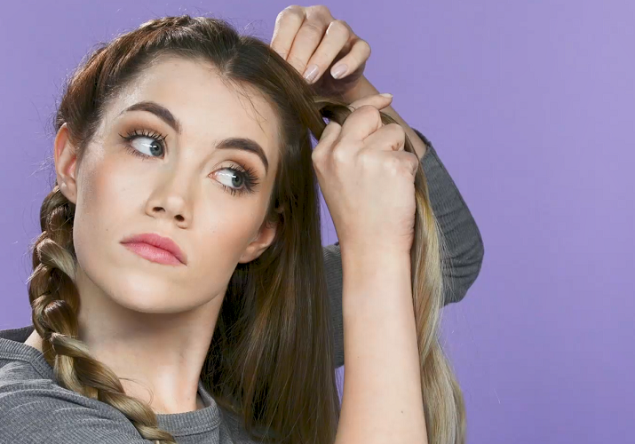 Woman braiding hair