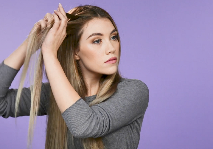 Woman starting to braid hair