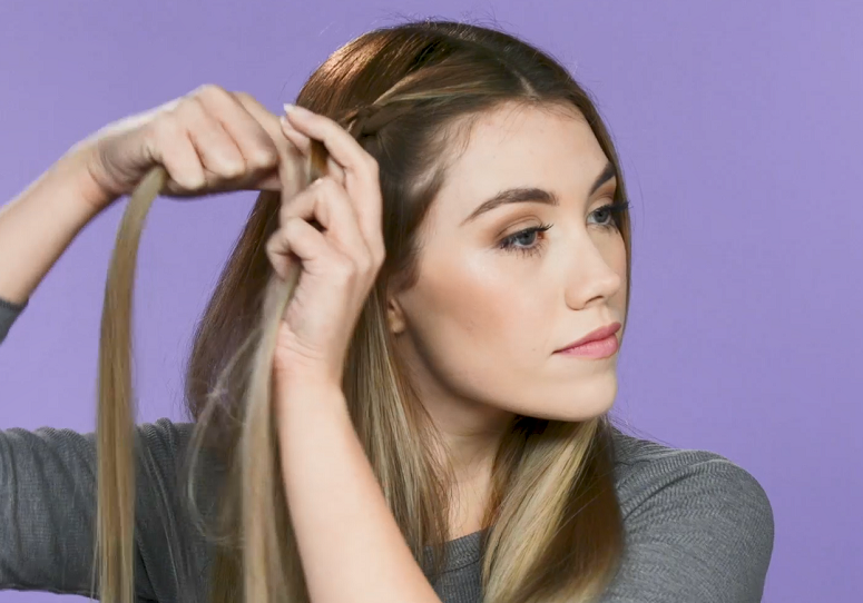 Woman braiding hair