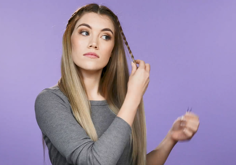 Woman pinning hair braid back