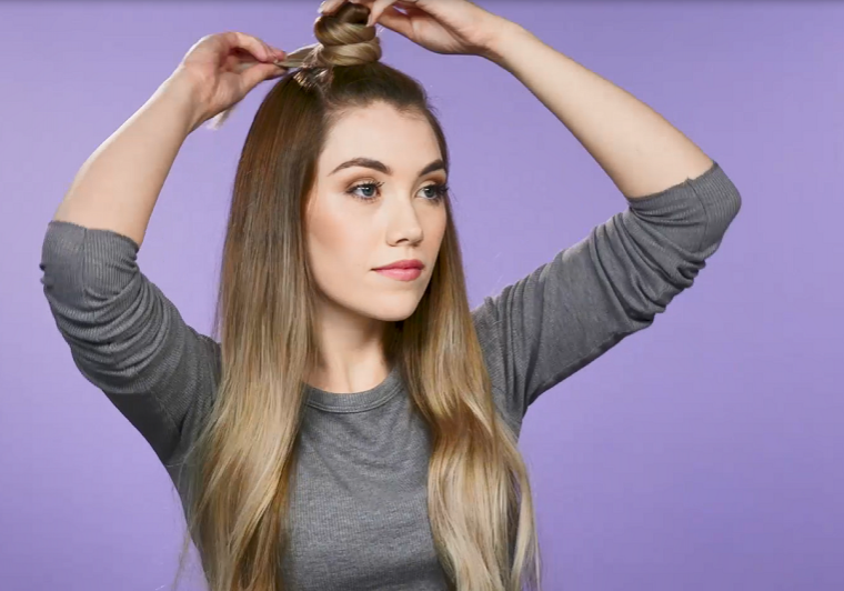 Woman creating top knot