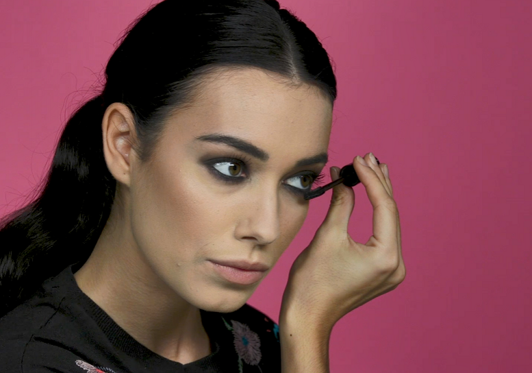 Woman creating smokey eye before Valentines Day date