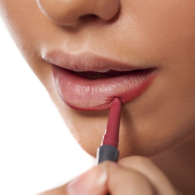 Girl applying lip liner