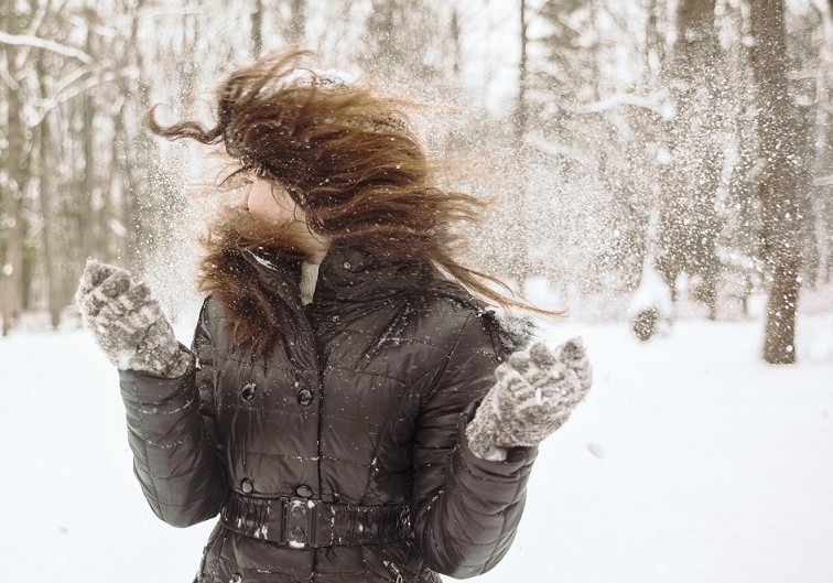 teenager long-haired girl play with snow